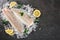 Fresh raw fillet white fish Pangasius with spices on ice over dark stone background.  Seafood, top view, flat lay, copy space