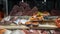 Fresh raw fishes on table in market stall for sale. Selling a tuna and salmon