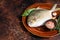 Fresh Raw Florida Pompano fish on a rustic plate. Dark background. Top view. Copy space
