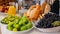 Fresh raw fruit, orange juice, apples, grapes, bagels and breads on a modern white kitchen table. Healthy eating. Organic food.