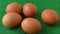 Fresh raw group of eggs put on green sack