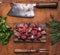 Fresh raw lamb chop on a cutting board for meat cleaver Meat fork herbs top view close up on wooden rustic background