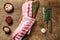 Fresh Raw lamb rack spare ribs with spices on a cutting board. Wooden background. Top view