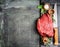 Fresh raw meat with herbs,spices and butcher knife on rustic background, top view, place for text. Cooking concept.