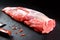 Fresh and raw meat. whole piece of Sirloin steaks in a row ready to cook. Background black blackboard