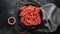 Fresh Raw mince, Minced beef, ground meat with herbs and spices on black plate