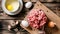 Fresh raw minced beef, garlic, onion on a cutting board and chicken eggs