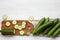 Fresh raw organic green cucumbers, top view. Flat lay, from above, overhead. White wooden background. Space for text