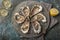 Fresh raw oysters on gray plate served with lemon, red onion and wine vinegar