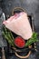 Fresh Raw pork Eisbein knuckle ham in a wooden tray with meat knife. Black Wooden background. Top view