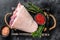 Fresh Raw pork Eisbein knuckle ham in a wooden tray with meat knife. Black Wooden background. Top view