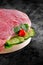 Fresh raw pork ham meat decorated with vegetables on kitchen table plus clipping path
