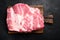 Fresh raw pork neck meat, on black dark stone table background, top view flat lay