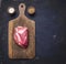 Fresh raw pork steak on vintage cutting board meat on a dark wooden background with pepper , salt with space for text