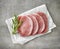 Fresh raw pork on white wrapping paper