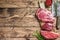 Fresh raw prime black angus beef steaks fillet Mignon, rib eye or cowboy, Striploin. Wooden background. Top view. Copy space
