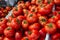 Fresh raw ripe tomatoes sold on outdoor market. Farm seasonal fruits and vegetables