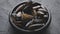 Fresh and raw sea mussels in black ceramic bowl placed on dark stone background