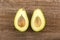 Fresh raw smooth avocado on brown wood