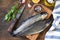 Fresh raw trout fish and pickle ingredients on a wooden table.