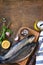 Fresh raw trout fish and pickle ingredients on a wooden table.