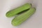 Fresh raw zucchini, courgette, Cucurbita  or squash vegetable marrow on a white background