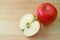 Fresh red apple whole fruit and its cross section on wooden table with copy space