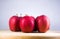 Fresh red apple on wooden table