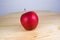 Fresh red apple on wooden table