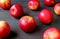 Fresh red apples scattered on dark colored wooden table