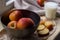 Fresh red apples in a stylish iron dish lying on a white window sill. Apple slices and a glass of milk are used as