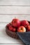 Fresh red apples in a wicker basket. Ripe fruits as a concept of a plentiful harvest. White background