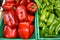 Fresh red bell pepper and green chilli in green plastic boxs at the outdoor fresh market