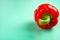 Fresh red bell pepper on light green background with copy space