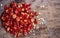 Fresh red chillies are cut into pieces and placed on a wooden chopping board