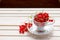 Fresh red currants in a cup on wooden table close up.Ripe large organic red currant .Summer fresh berries.agriculture