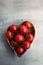 Fresh red delicious tomatoes in heart-shape plate