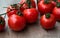 Fresh red delicious tomatoes on an old wooden tabletop, select