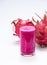 Fresh red dragon pitaya fruit juice in glass mug. Close up on white background with clipping path