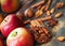 Fresh red and green apples, cinnamon sticks, ground cinnamon, an