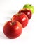 Fresh red and green apples diagonally on white