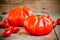 Fresh red heirloom tomatoes on a wooden background