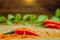 Fresh red hot chili peppers on chilli dried chopped with rustic wood background. Concept of hot food and Vegetable