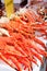 Fresh red king-crab legs in ice at seafood market