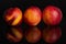 Fresh red nectarine isolated on black glass