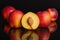 Fresh red nectarine isolated on black glass