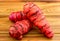 Fresh red new zealand yams (pink oca) on wood