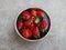 Fresh Red Strawberries floating on water in a bowl