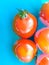 Fresh red tomato floating blue sink