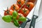 Fresh red tomatoes with basil leaf and knives